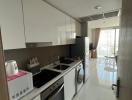 Modern kitchen with white cabinetry and built-in appliances