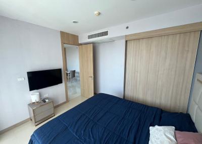 Modern bedroom with large bed and built-in wardrobe