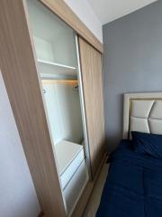 Compact bedroom with built-in wardrobe and comfortable bed