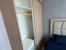 Compact bedroom with built-in wardrobe and comfortable bed