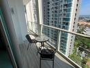 High-rise apartment balcony with outdoor seating and city view