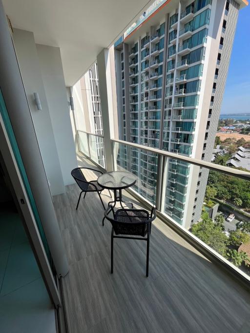 High-rise apartment balcony with outdoor seating and city view