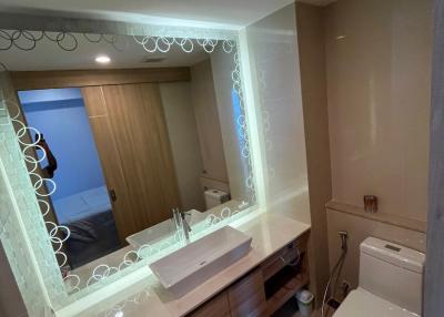 Modern bathroom with illuminated mirror and vanity