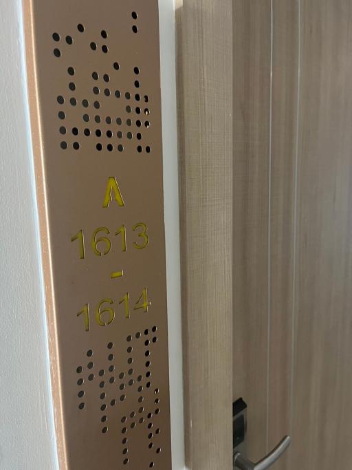 Apartment door number plaque in a building