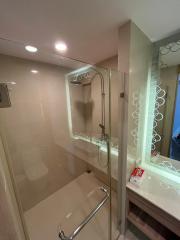 Modern bathroom with glass shower enclosure and elegant lighting
