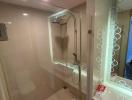 Modern bathroom with glass shower enclosure and elegant lighting