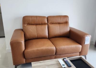 Modern living room with a comfortable leather sofa and stylish coffee table