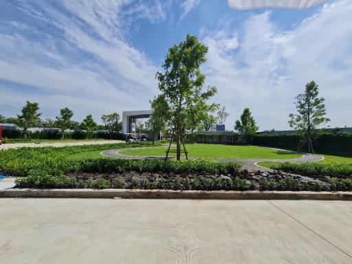 Expansive landscaped garden with a walking path and a gazebo