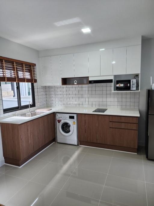 Modern kitchen with wooden cabinets and stainless steel appliances