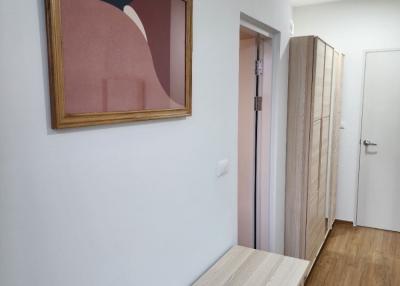 Modern hallway with wooden floors and wall art