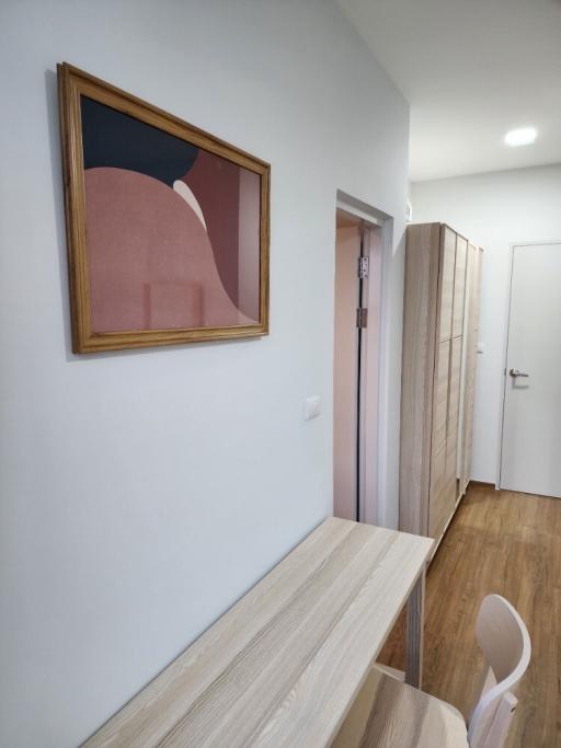 Modern hallway with wooden floors and wall art