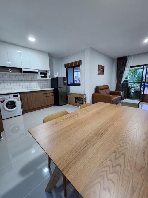 Spacious combined kitchen and living area with modern appliances