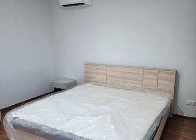 Spacious bedroom with a new king-sized bed and air conditioning unit
