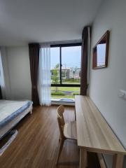 Cozy bedroom with large window and garden view