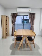 Modern dining room interior with a wooden table and chairs