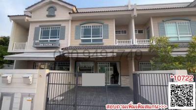 Front view of a two-story residential house with a gated entrance