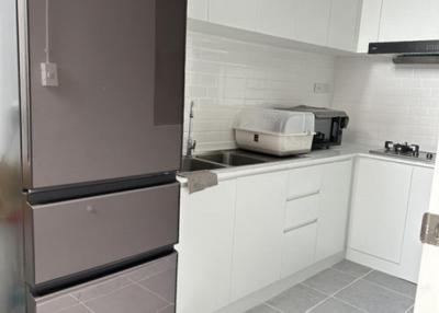 Modern kitchen with stainless steel appliances and white cabinetry