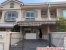 Exterior view of a two-story residential house with gated entrance