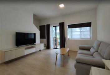 Spacious living room with modern furniture and ample natural light