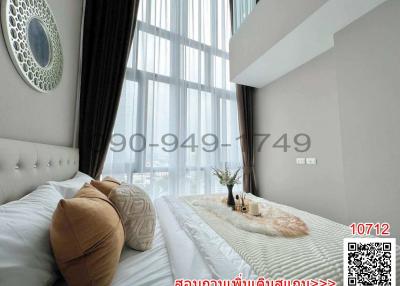 Modern bedroom with large windows and elegant decor