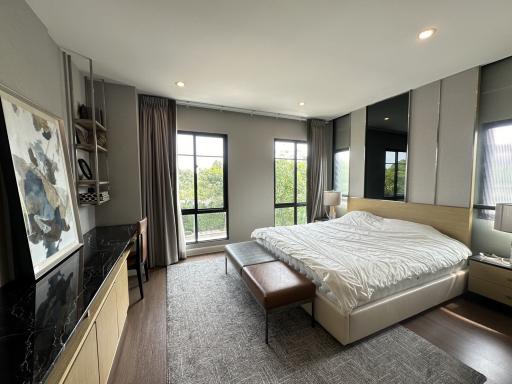 Spacious bedroom with modern furnishings and natural light