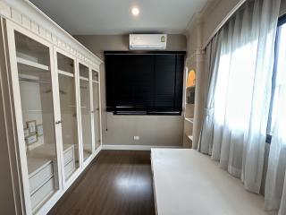 Modern bedroom with built-in wardrobes and air conditioning