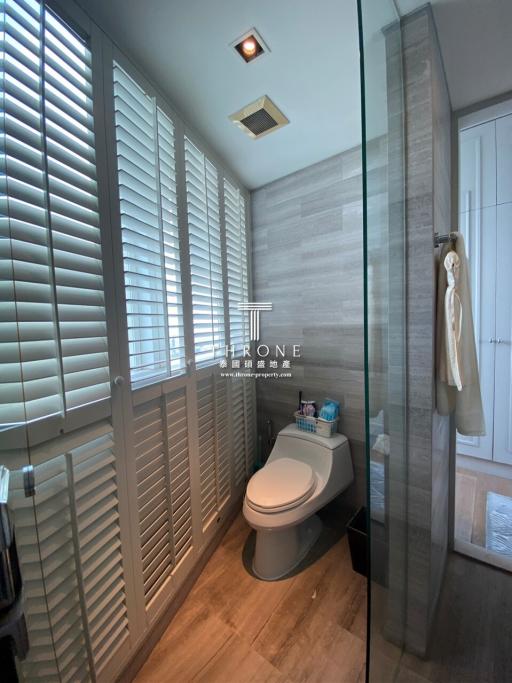 Modern bathroom interior with shutters and glass shower