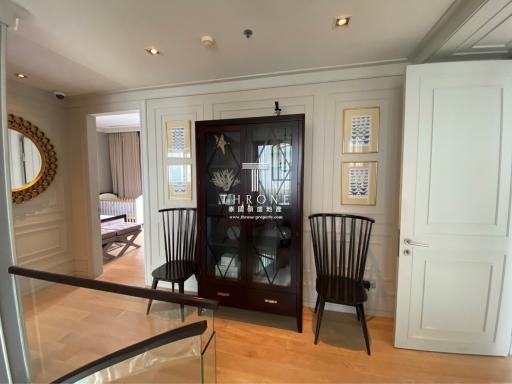 Elegant hallway interior with decorative doors and wooden chairs