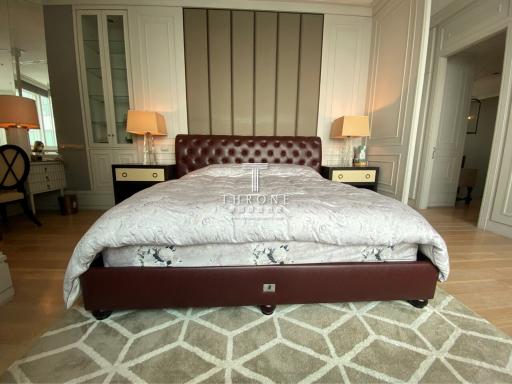 Elegant bedroom with a large leather bed and geometric pattern rug