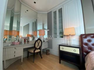 Elegant bedroom interior with a classic design featuring a writing desk and mirror