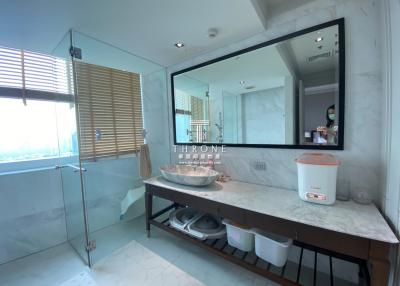 Modern bathroom with large mirror and city view