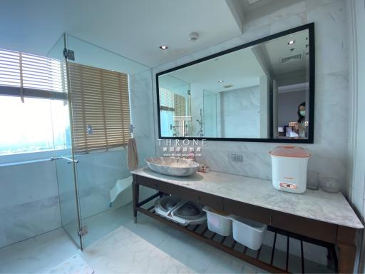 Modern bathroom with large mirror and city view