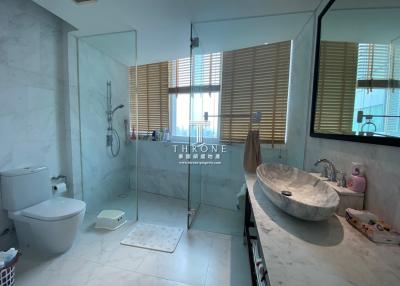Modern bathroom interior with glass shower and elegant basin