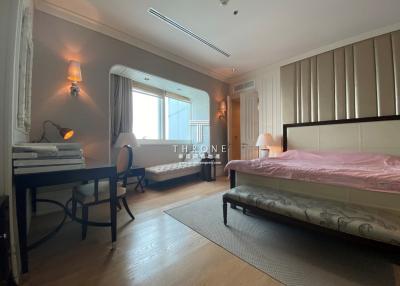 Spacious bedroom with natural light and modern furnishings