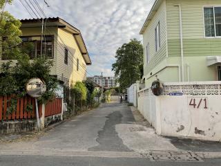 Residential street view with houses and cloudy sky