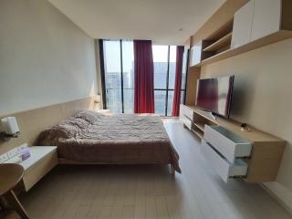 Modern bedroom with large window and mounted television