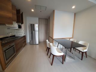 Modern kitchen and dining area with stainless steel appliances