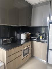 Modern kitchen with stainless steel appliances and wooden cabinets