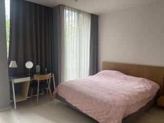 Modern bedroom with large windows and natural light