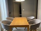 Modern dining room with wooden table and grey upholstered chairs