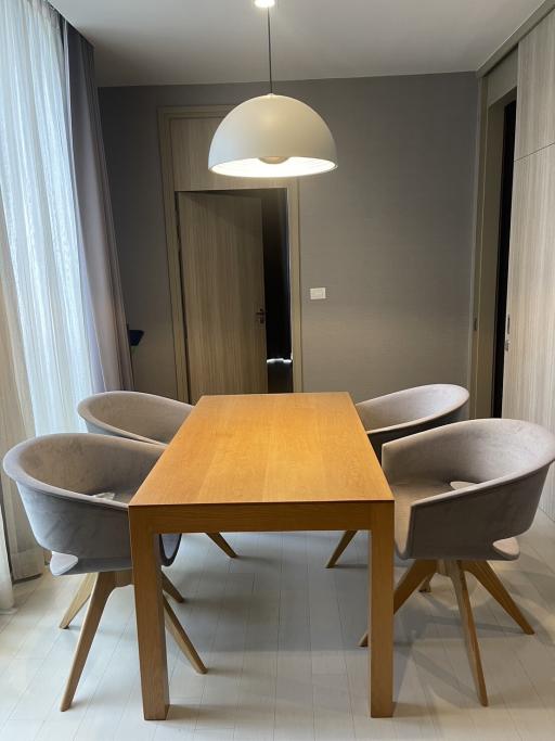 Modern dining room with wooden table and grey upholstered chairs