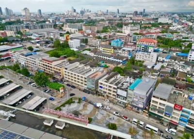 Aerial view of a bustling cityscape with various buildings and streets