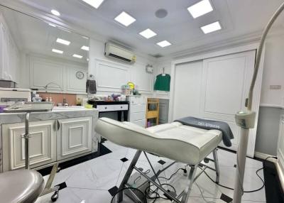Modern medical examination room with white interior and professional equipment