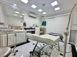 Modern medical examination room with white interior and professional equipment