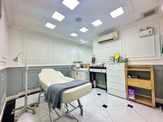 Modern clinic room with medical examination bed and sanitation station