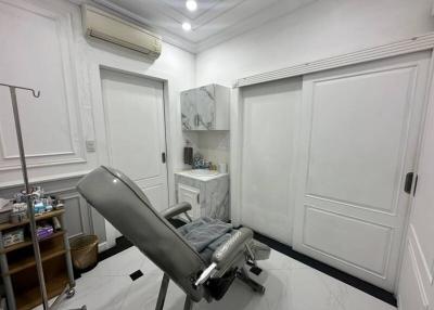 Modern clinic room with professional treatment chair and white decor