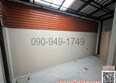 Spacious empty garage with a large shutter door