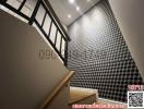 Modern staircase with geometric wallpaper and wooden steps
