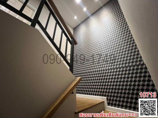 Modern staircase with geometric wallpaper and wooden steps