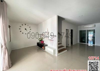 Spacious and modern living room interior with white walls and tiled floor